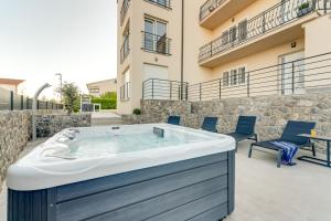 a jacuzzi tub on the patio of a building at Cosmopolitan Apartments in Krk