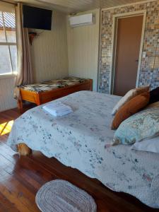 Cama ou camas em um quarto em Pousada Recanto do Lago