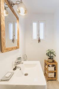 a bathroom with a white sink and a mirror at Fonduco in Mahón