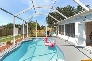 The swimming pool at or close to Family friendly 4BR Home in St Lucie Cty with Pool, BBQ and Firepit!