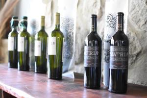 a group of wine bottles sitting on a table at Posada de las Viñas in Tolombón