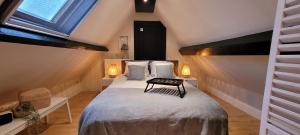 a bedroom with a large bed in a attic at Sea-renity 23 met sauna en jacuzzi in Eggewaartskapelle