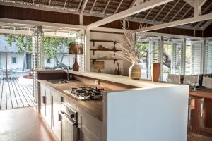 a kitchen with a stove top oven next to a patio at Ananda Atins in Atins