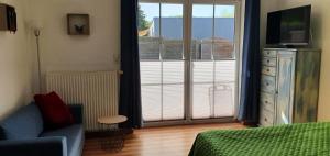 a bedroom with a bed and a tv and a window at Ferienwohnungen Rügen-Glück in Lohme
