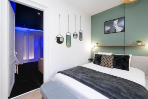 Un dormitorio con una gran cama blanca y una ventana en Art Déco Champagne & Spa en Reims