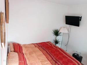 a bedroom with a bed with a red blanket at Kalmarapartment in Kalmar