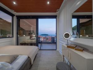a bedroom with a bed and a view of the ocean at Misisuone Apartments Budva in Budva