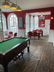 a pool table in a room with tables and chairs at The Farmers Union in Exeter