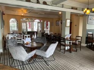 a dining room with tables and chairs and tables and tablesktop at The Farmers Union in Exeter