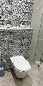 La salle de bains est pourvue de toilettes blanches et de carrelage. dans l'établissement Tiwaline Tarsime App C, à Sidi Ifni 23 autres photos