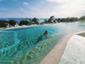 a young boy in the water at a swimming pool at MiraMa MobileHome in Selce