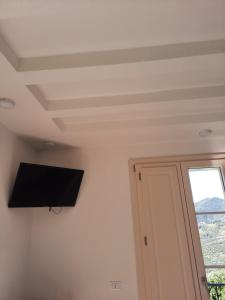 a room with a flat screen tv on the ceiling at B&B Cà di Bollo in Moneglia
