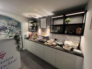 a kitchen with a counter with food on it at Pension Triebischtal in Meißen