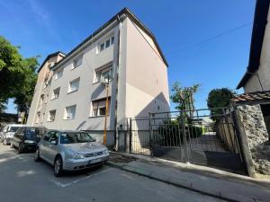 a silver car parked in front of a building at Apartman Venera in Sombor