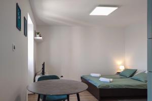 Habitación pequeña con cama y mesa en Studio apartment above promenade w terrace & parking, en Rabac
