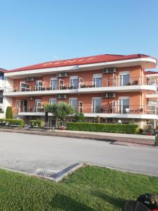 an apartment building on the side of a street at Denis Studios and Apartments in Paralia Katerinis