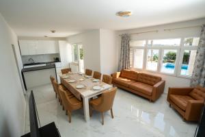 a kitchen and living room with a table and chairs at Villa Lucini Dvori in Novalja