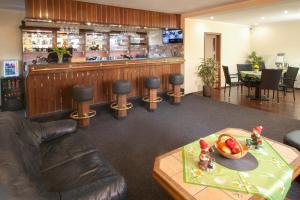 a lobby with a bar with a table and chairs at Pension RELAX U Komína in Františkovy Lázně