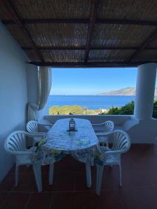 a table and chairs in a room with a view of the ocean at Casa Katia in Lingua +31 photos