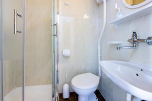 a bathroom with a toilet and a sink and a shower at Apartment Arya in Crikvenica +10 photos