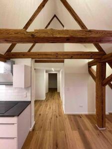 an empty kitchen with wooden floors and wooden beams at Historische Unterkunft in Lorch in Lorch