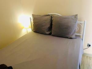 a bed with two pillows on it in a room at ''559 Cap corniche'' T2 en résidence front de mer! in Sète +10 photos