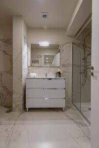 a bathroom with a white dresser and a mirror at Green Apartment Pedras Salgadas in Pedras Salgadas