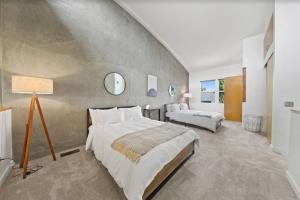 a large bedroom with two beds and a lamp at New York Style Penthouse in the heart of the city in San Diego