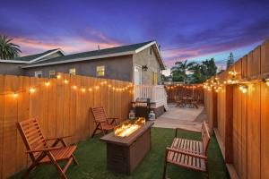 a backyard with a fence with chairs and a fire pit at Trendy San Diego Home with Outdoor Space in San Diego