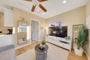 a living room with a large television and a table at Trendy San Diego Home with Outdoor Space in San Diego +10 photos