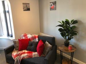 a living room with a couch and a potted plant at 01 Holmfield in Blackpool