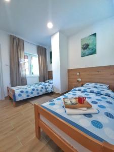 um quarto com 2 camas e uma mesa com uma chávena em Pool and Villa Splav Dunavac em Futog