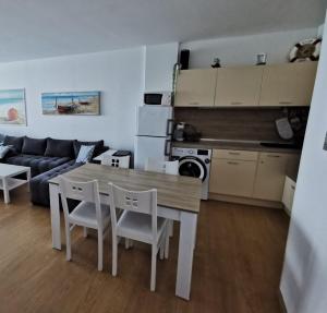 a kitchen and a living room with a table and chairs at Silver A 27 in Byala