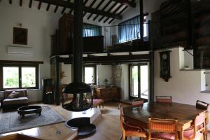 a living room with a large wooden table and chairs at Casa La Gorga in Cagli