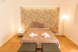 a bedroom with a large bed with towels on it at Le Dimore di Puglia - Palazzo Ladogana in Monopoli