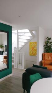 a living room with a couch and a mirror at Designed Penthouse, Amsterdam city center in Amsterdam