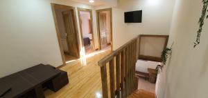 a view of a room with a staircase and a television at Donde Empieza el Paraiso in Gijón