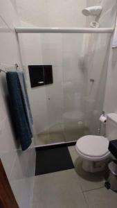 a bathroom with a toilet and a shower at Vale do Sossego Chalés in Domingos Martins