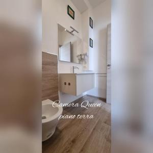 a white bathroom with a sink and a toilet at B&B D'AMARE in Cupra Marittima