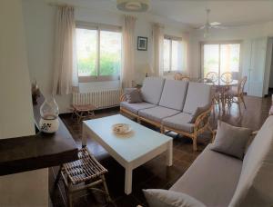 een woonkamer met een bank en een tafel bij Belle Maison proche plage in Muro