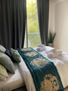 a bed with towels on it in front of a window at 5 minutes walk to the sea appartement in Casablanca