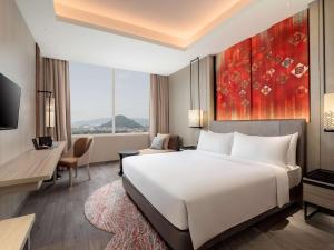 Ένα ή περισσότερα κρεβάτια σε δωμάτιο στο Radisson Lampung Kedaton