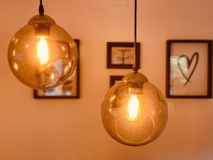 zwei Lichter hängen an einer Wand mit Bildern in der Unterkunft Cascais Sun Apartment in Cascais