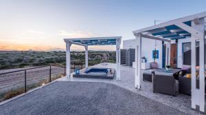 a house with a swimming pool on a balcony at Santa Marina Milos in Mytakas