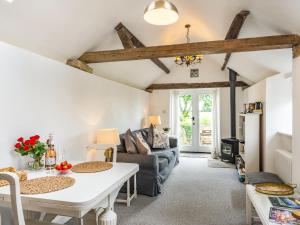 a living room with a table and a couch at Owl's Nest in Stearsby