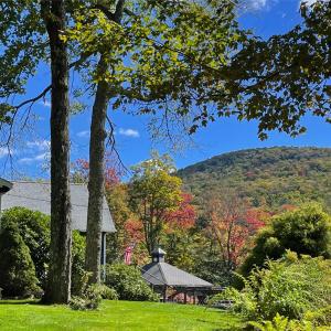 a house with a gazebo and fall foliage at The Blue House On The Hill Catskills—Views in Claryville