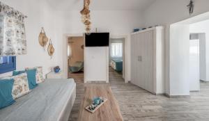a living room with a couch and a table at Santa Marina Milos in Mytakas