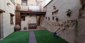 une cour d'un immeuble avec une pelouse verte dans l'établissement Casa Rural "La Cabaña de Andrés ", à Corrales