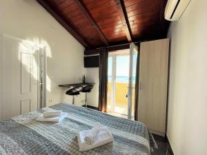a bedroom with a bed with two towels on it at Villa Sunset in Mlini