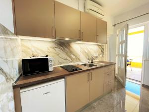 cocina con microondas y fregadero en Villa Sunset en Mlini